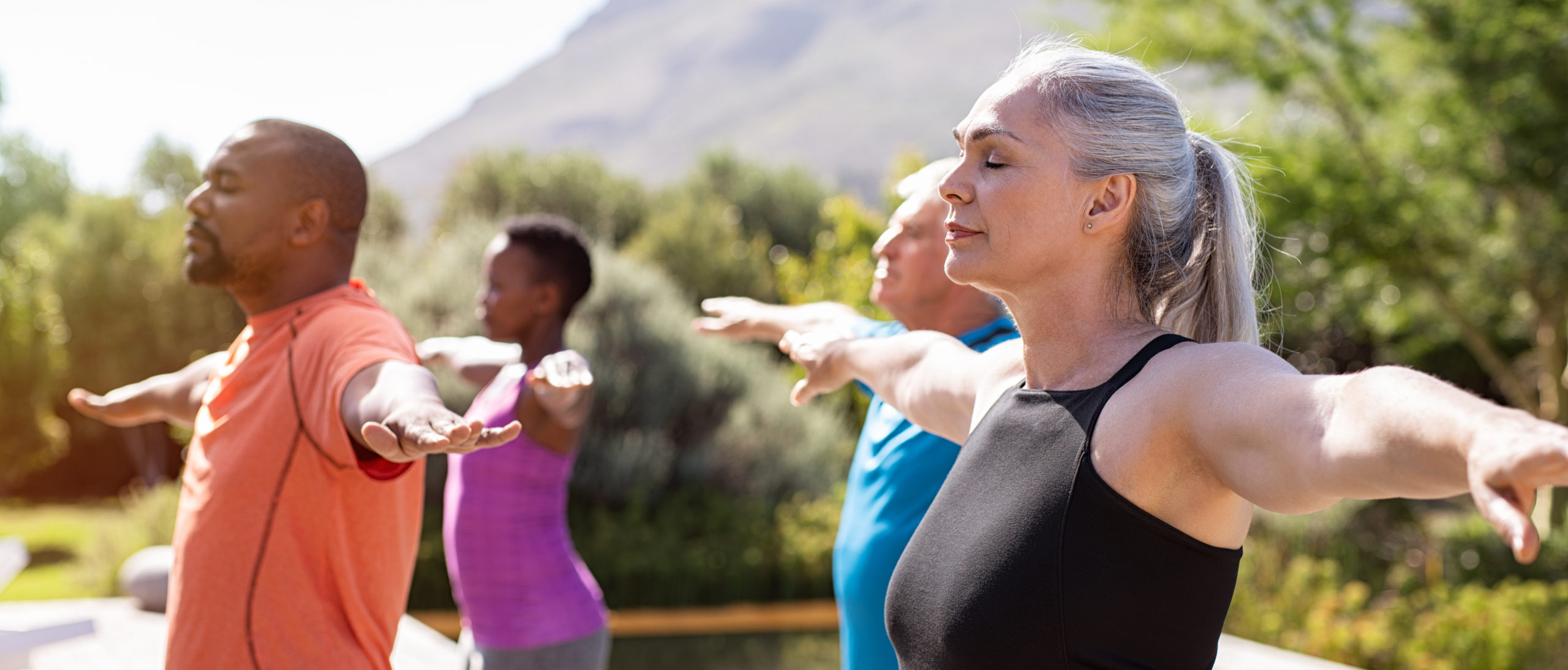 Group,Of,Senior,People,With,Closed,Eyes,Stretching,Arms,Outdoor.